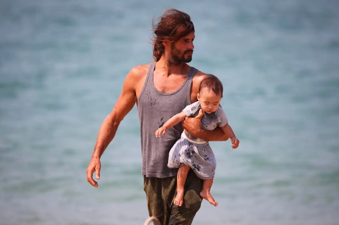Viktor walking with his daughter on the beach